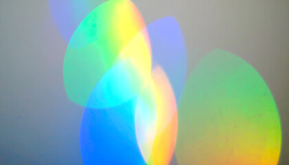 Abstract background with soft, ethereal rainbow light leaks and colorful bokeh effects. A dreamy and vibrant visual concept.