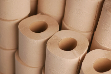 Roll of natural paper towels stacked in a storage area.