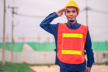 Asian engineer or Asian worker standing construction background