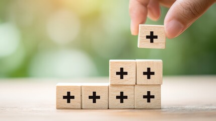 Building Success: Hand Placing Wooden Block with Plus Sign for Growth and Positive Reinforcement