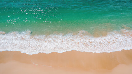 Obraz premium Aerial view of serene beach with turquoise water and gentle waves lapping at golden sand