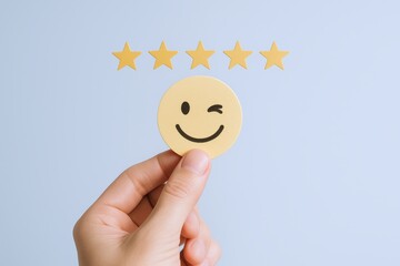 Customer feedback concept featuring a hand holding a winking smiley face with five stars above on light blue
