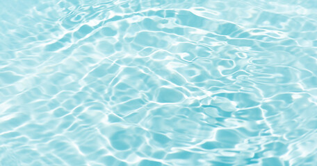 Blue water with ripples on the surface. Defocus blurred transparent blue colored clear calm water surface texture with splashes and bubbles. Water waves with shining pattern texture background.