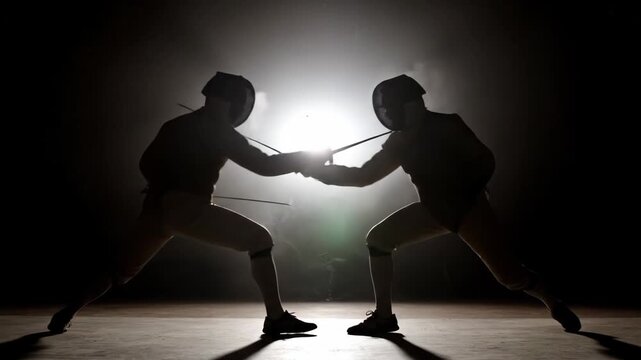 Silhouetted Fencers in Dramatic Duel - Two fencers, silhouetted against a bright background, engage in a dynamic fencing duel.