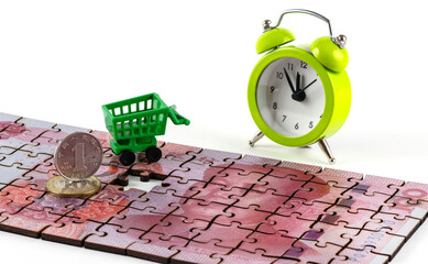 A puzzle piece of a 100 yuan bill, a 1 yuan coin and a miniature supermarket shopping cart