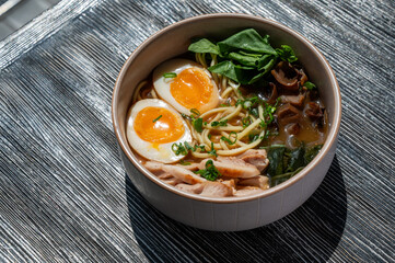 Ramen soup in cafe on wooden table. 