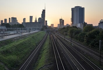 The morning sun illuminates the tops of skyscrapers. Morning trains go along the rails to the still empty platforms. Morning, summer Warsaw. © Uladzimir Hryhoryeu