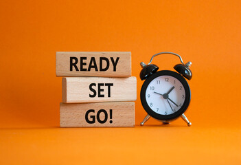 Ready Set Go symbol. Concept words Ready Set Go on wooden blocks. Beautiful orange background with...
