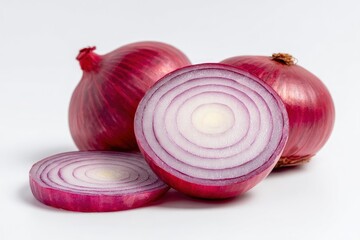 Three red onions on a white background two whole and one sliced in half with a slice in front