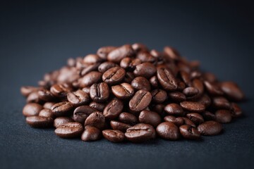 Fototapeta premium Rich brown coffee beans scattered, showcasing texture and qualit