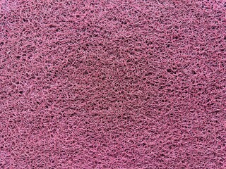 Red rubber foot mat texture. Patterned doormat rug background. Rubber doormat.