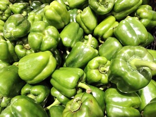top down view of full frame shoot of big fresh green capsicum or green bell peppers. selective focus. showcasing natural ingredient cooking healthy food.