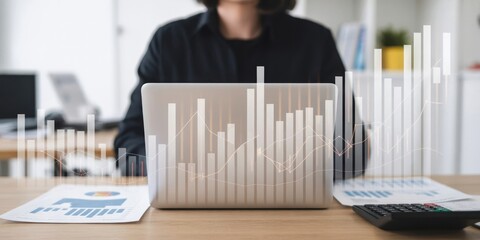 Business Performance - A woman working at her desk, with a financial bar chart and line graphs overlaying her laptop, symbolizing data analysis