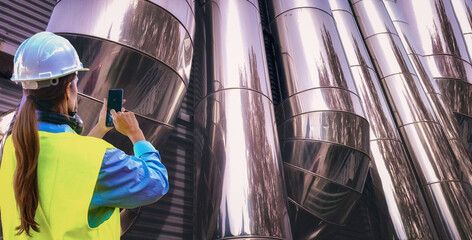 Engineer taking pictures of hvac pipes using mobile phone for maintenance and inspection