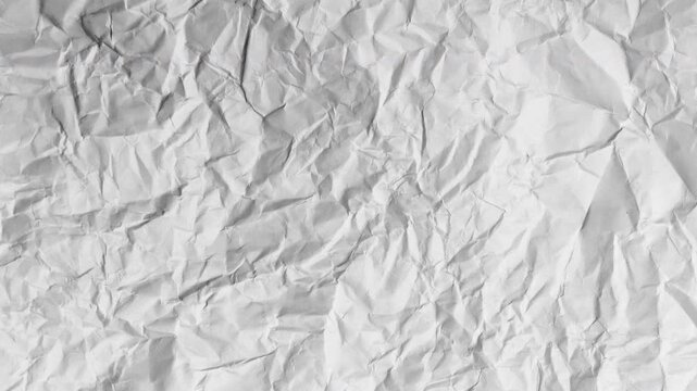 Abstract Crumpled Paper Transition,Animated stop motion of wrinkled white paper unfolding on a black background. A creative, textured reveal for intros or overlays.