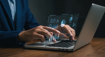 Hands typing on laptop with futuristic digital data overlay