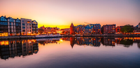 Fototapeta premium Gdansk with Motlawa river in Poland. Old town colourful house with Stragania Gate