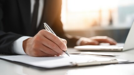 Executive Signing Business Document with Pen on Desk in Bright Modern Office Setting