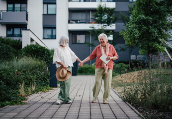 Older woman enjoying a walk with her aging mother.