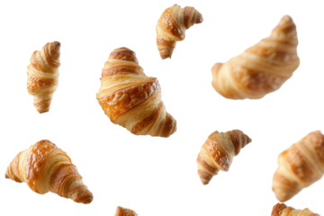 Croissant soaring in mid-air over bright kitchen backdrop evokes fresh baking atmosphere