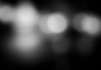 Abstract black and white blurred light streaks with grain texture, creating a dreamy and mysterious cosmic atmosphere.