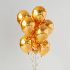 Cluster of golden metallic balloons against a plain background