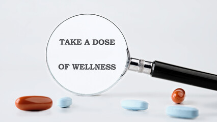 The concept phrase is TAKE A DOSE OF WELLNESS. Health concept. Pharmacological preparations, medicinal products