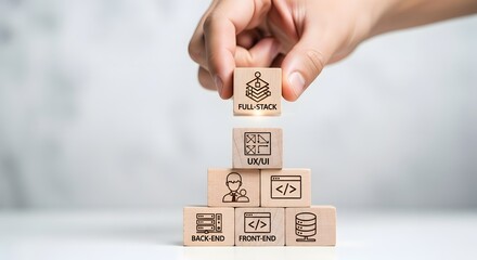 Businessman's hand building a pyramid of wooden blocks symbolizing the structure of full-stack software development and technology skills
