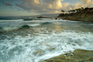 Obraz premium Cyprus Mediterranean Coastline with Turquoise Sea, Sandy Beach, and Clear Blue Sky