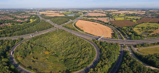 Aerial panoramic view of Croft Interchange (Junction 21A), where the M6 and M62 motorways connect near Birchwood village in Warrington UK  © bardhok