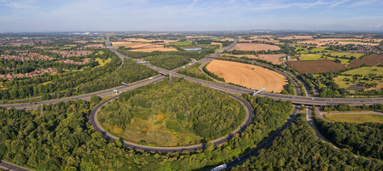 Aerial panoramic view of Croft Interchange (Junction 21A), where the M6 and M62 motorways connect near Birchwood village in Warrington UK  © bardhok