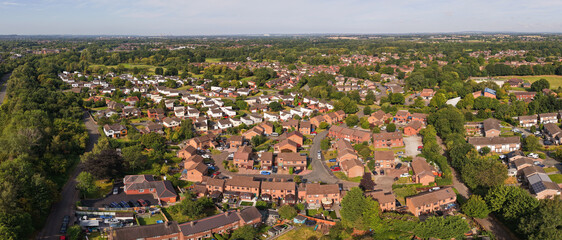 Obraz premium Aerial panoramic view of Birchwood village in Warrington, showcasing a mix of residential neighborhoods, green spaces