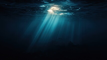 Sunlight beams pierce dark underwater depths