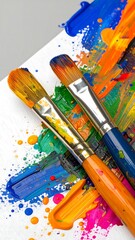 Obraz premium Colorful paint brushes on vibrant artwork