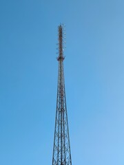 Tall Cellular Communication Tower Against Clear Blue Sky &ndash; Steel Lattice Structure with Antennas for Mobile Network Signal Transmission in Surabaya, East Java, Indonesia