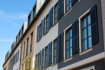 Fototapeta premium Row of modern townhouses, various colors, with dark shutters
