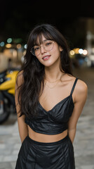 Fototapeta premium Smiling brunette in black crop top at night