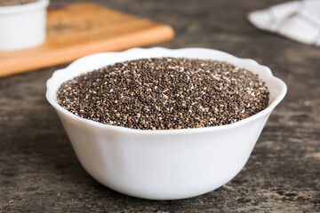 Chia seeds in bowl on colored background. Healthy Salvia hispanica in small bowl. Healthy superfood