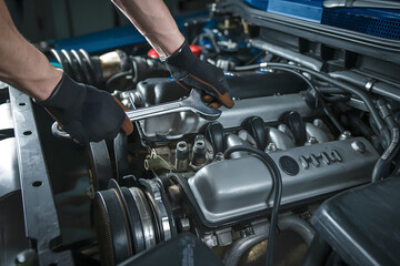 Close-up of a mechanic repairing a car engine. AI Generated 