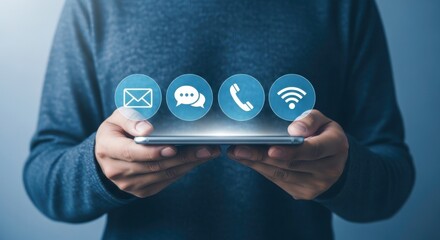Person holding smartphone with email chat phone and wifi icons floating above the screen in blue light
