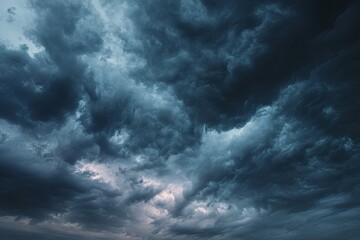 Dark, ominous clouds fill the sky, hinting at a brewing storm.  Dense, textured clouds in various shades of gray and dark blue, suggesting impending weather