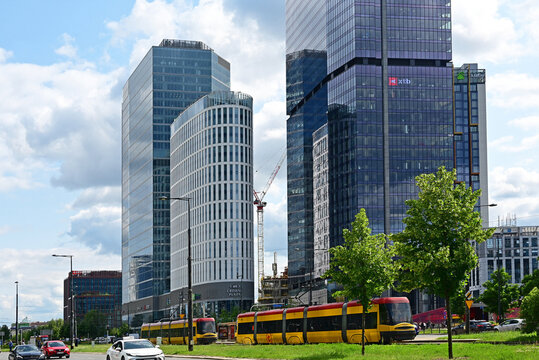 Warsaw, Wola, Poland, Europe : Rondo Daszyńskiego, The Hub complex, office skyscrapers and elliptical hotel building with 4 star Crowne Plaza and 5 star Holiday Inn Express, at right Skyliner