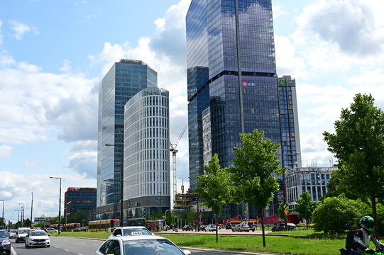 Warsaw, Wola, Poland, Europe : Rondo Daszyńskiego, The Hub complex, office skyscrapers and elliptical hotel building with 4 star Crowne Plaza and 5 star Holiday Inn Express, at right - Skyliner