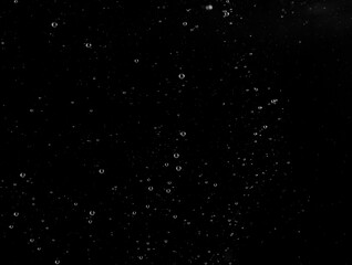 Underwater bubbles, Underwater oxygen design concept, Small water drops underwater, On black background, Close-up photography.