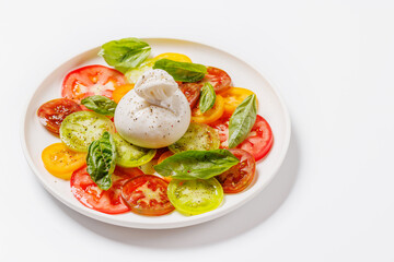 Fresh burrata served on slices of colorful tomatoes