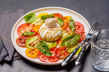 Fresh burrata served on slices of colorful tomatoes