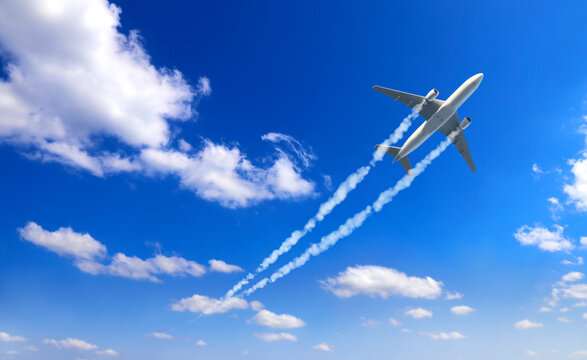 Horizontal nature background with aircraft and Jet trailing smoke in sky. Airplane and condensation trail. Foggy jet trail and plane in blue sky with white clouds. Traveling the world concept