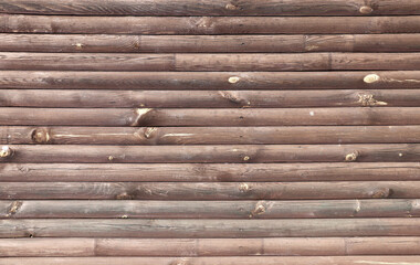 Texture of old wooden board of brown color. Horizontal or vertical background with weathered retro wood planks. Wall with pine boards trim. Texture of an aged wooden panels, its hue a deep brown