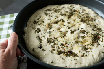 Preparation of the dough with spices and herbs in a frying pan