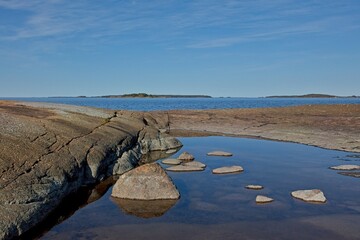 Fototapeta premium Rocky seashore on the island of Suuri-Pisi in sunny spring weather, Virolahti, Finland.
